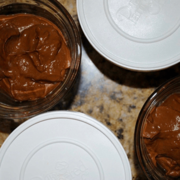 Three bowls of chocolate fudge, certified by a nutritionist, sitting on a counter.