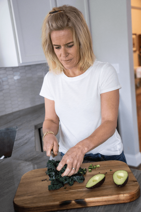 Nutritionist chopping kale.