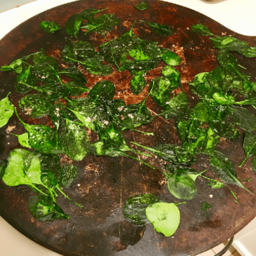 Oven-Baked Spinach Chips on wood board